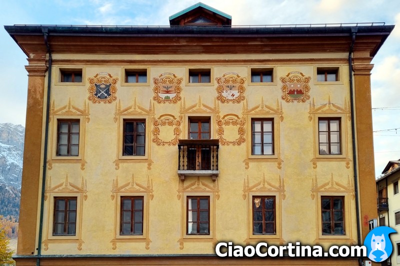 The coats of arms of the Ampezzo families on the facade of Comun Vecio