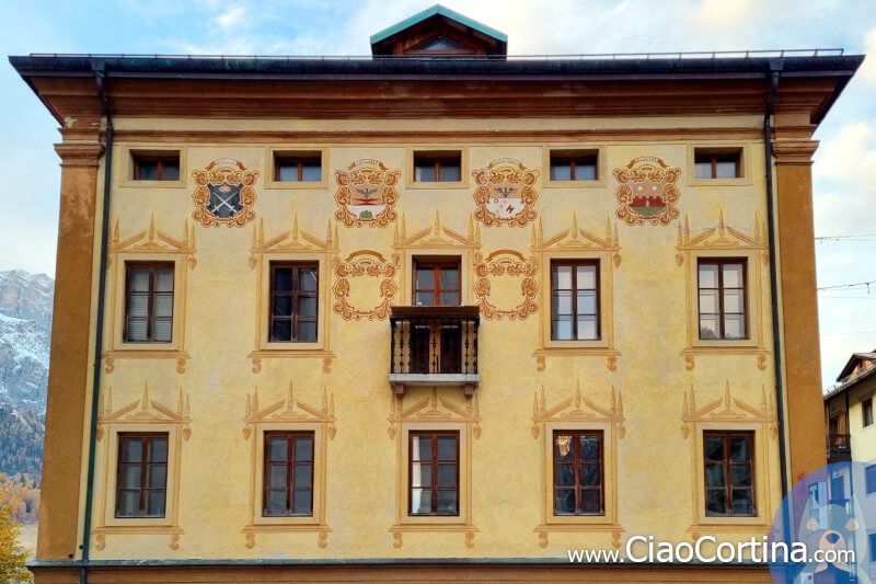 The coats of arms of the Ampezzo families on the facade of Comun Vecio