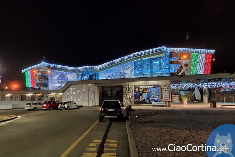 Cortina Ice Stadium illuminated with the Italian flag at night